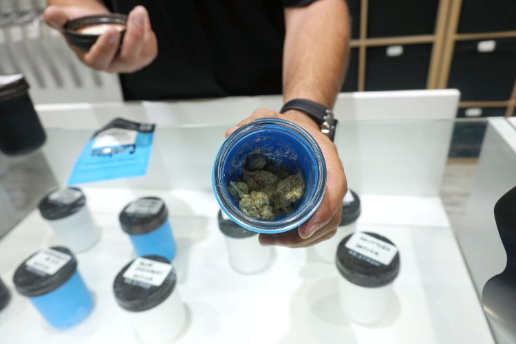 dispensary retail budtender showing bud